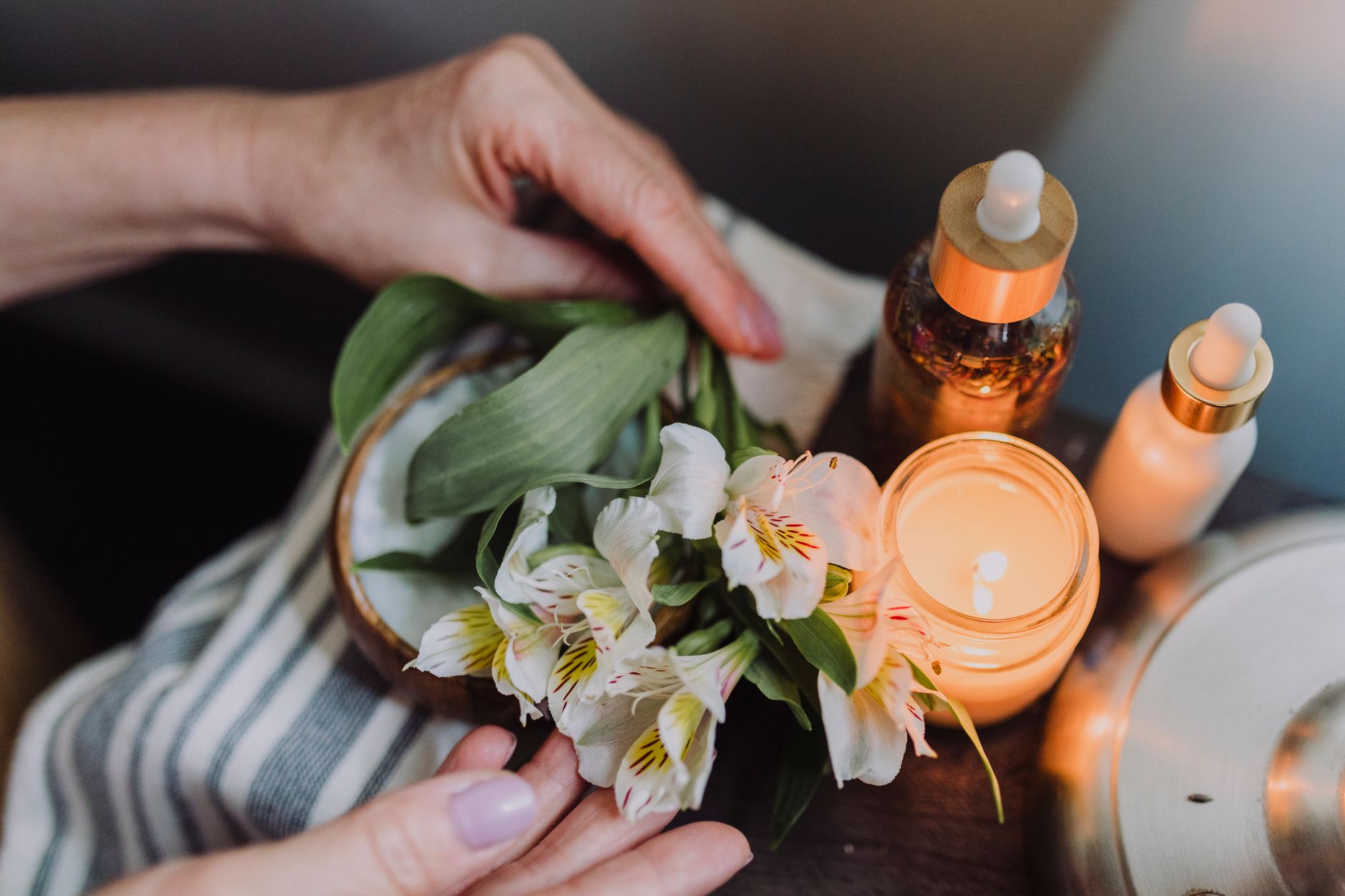 Spa oils and flowers arranged in a bowl